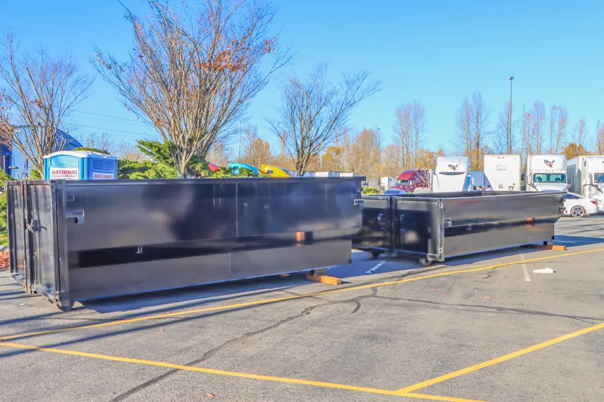 Professional dumpster rental service with roll-off container on residential driveway in Carver